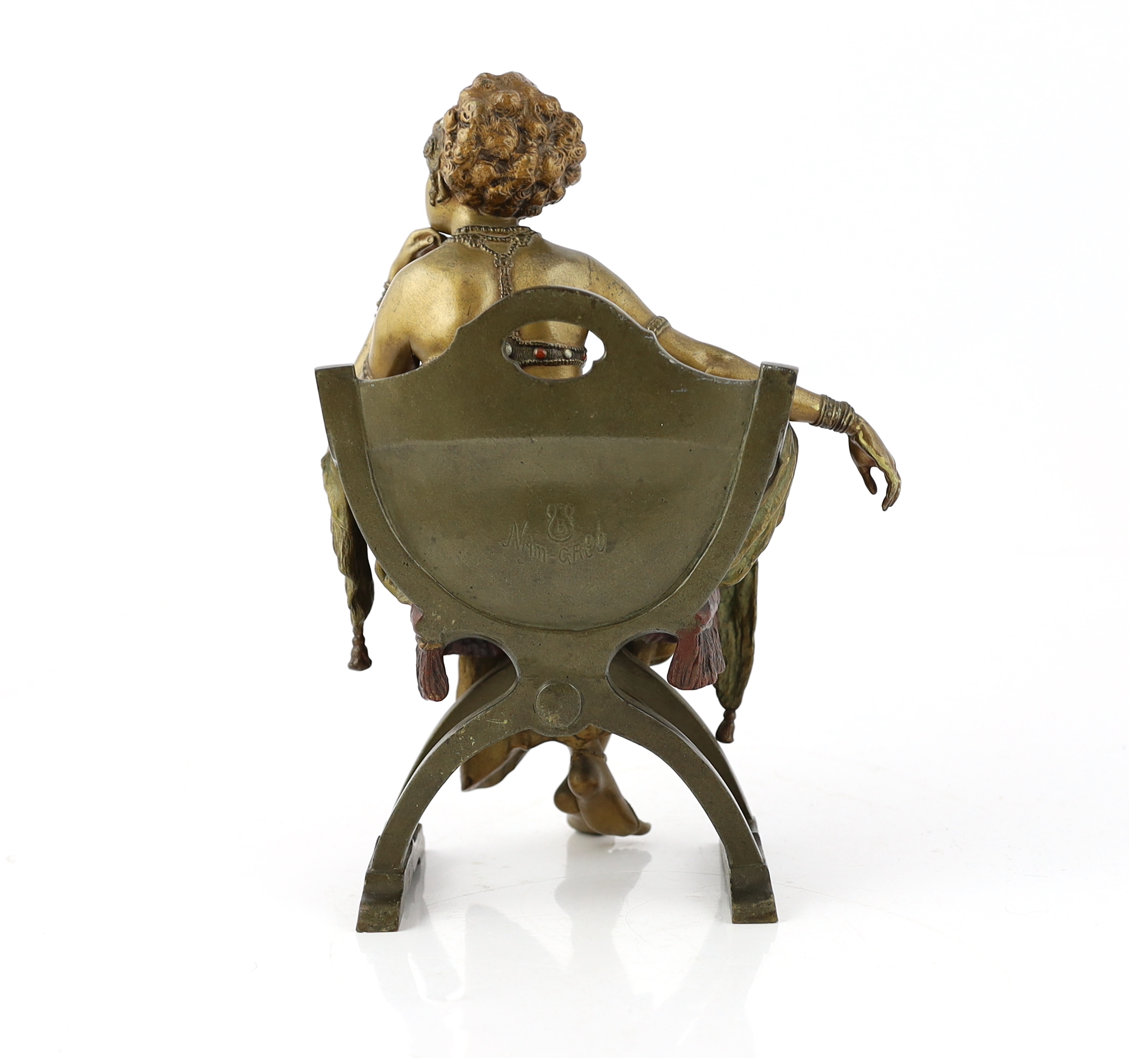 Franz Xavier Bergmann (1861-1936). An Austrian cold painted and patinated cast bronze figure of a Turkish dancing girl seated in an armchair, 20cm wide, 29cm high, Please note this lot attracts an additional import tax o